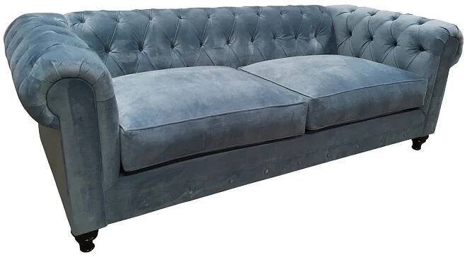 Blue velvet chesterfield with wood turned legs