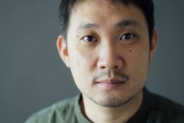 A Japanese director poses for the camera.