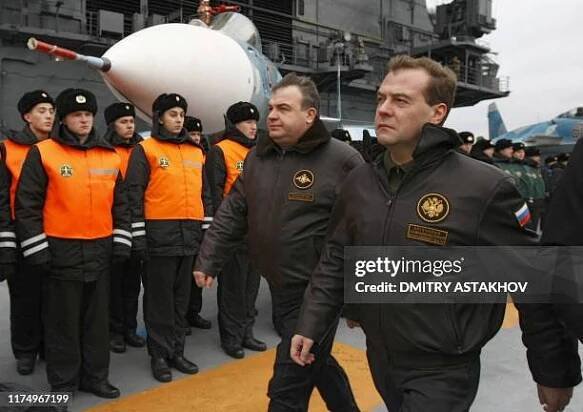 Russian President and Supreme Commander Dmitry Medvedev and Defense Minister Anatoly Serdyukov walk aboard the aircraft carrier, heavy cruiser the...