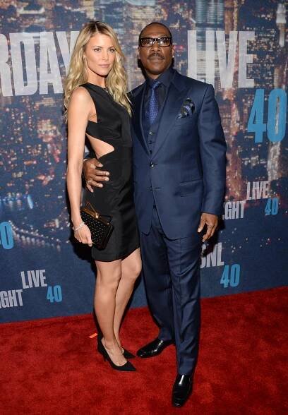 Paige Butcher, left, and Eddie Murphy arrive at the Saturday Night Live 40th Anniversary Special at Rockefeller Plaza on Sunday, Feb. 15, 2015, in New York. 