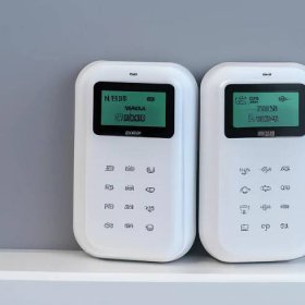 The photo shows a GSM alarm system with batteries, offering reliable and remote home security monitoring. Sigma 85 mm f/1.4. No text.. Sigma 85 mm f/1.4. No text.