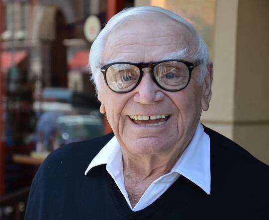 A Smiling Ernest Borgnine in Eyeglasses Wallpaper