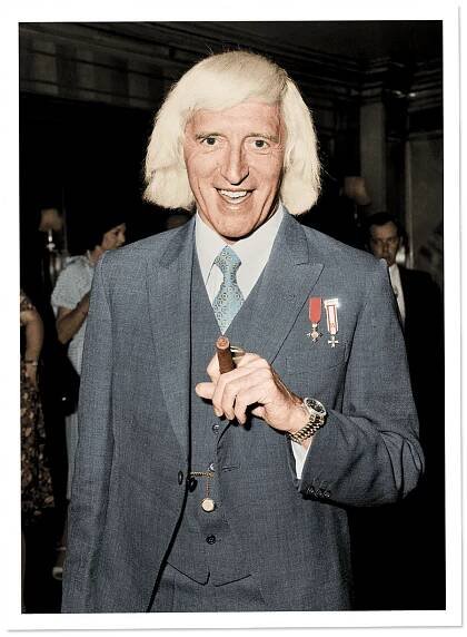 This image may contain Jimmy Savile Suit Coat Clothing Overcoat Apparel Human Person Fashion Premiere and Tie