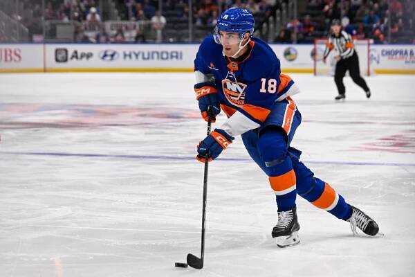 Pierre Engvall carries the pucks for the New York Islanders against the Calgary Flames.