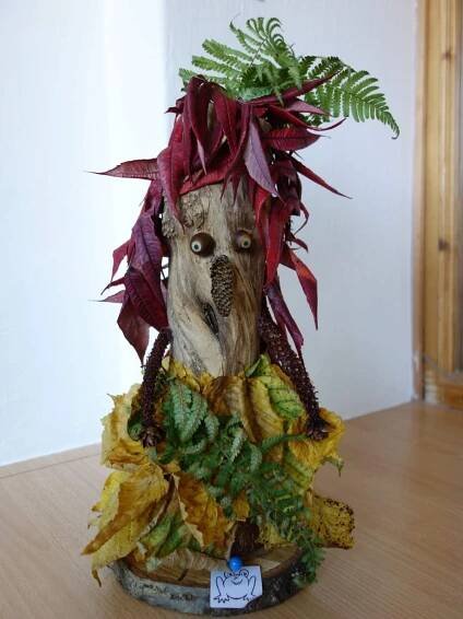 a planter with leaves and plants in it on a table