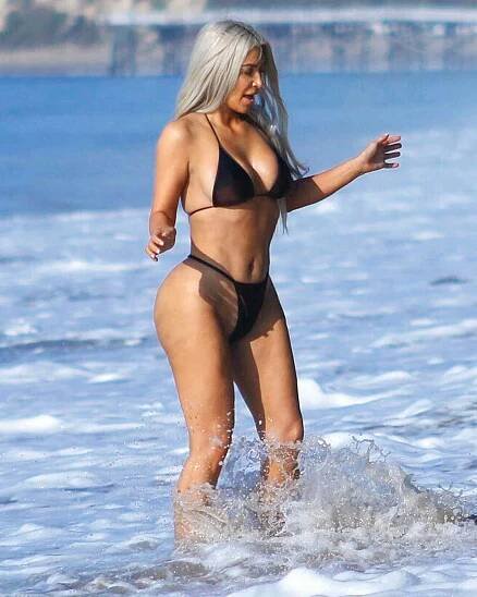 EXCLUSIVE: **PREMIUM EXCLUSIVE RATES APPLY STRICTLY NO WEB UNTIL 1PM EST WED SEPT 20TH** Bikini-clad Kim Kardashian has fun on the beach with friend in Malibu, CA. MANDATORY BYLINE DPXIMAGES