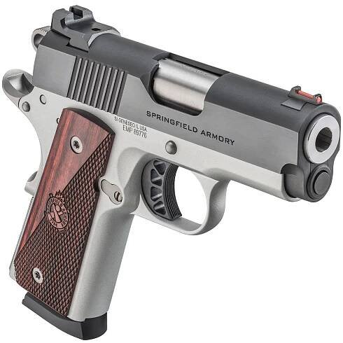 This photo features the Springfield Armory Ronin EMP 1911 compact pistol. The handgun is a reduced-size 1911 chambered in 9mm, designed for concealed carry and everyday use. It retains the classic 1911 design elements such as the grip safety, thumb safety, and crisp single-action trigger. The Ronin EMP has a shorter barrel and slim grip frame compared to a standard government model. Its two-tone finish and checkered grips give it a distinctive appearance while maintaining functionality. The pistol’s lightweight build and compact dimensions make it easier to carry than a full-size .45 ACP model. The image highlights the adaptability of the 1911 design to different sizes and calibers.