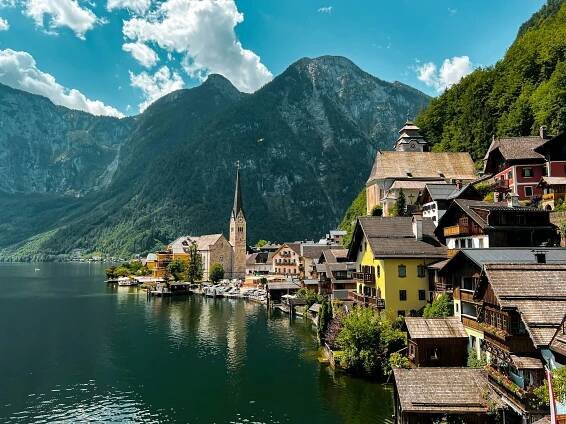 Scenic village by a lake and majestic mountains.