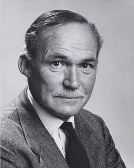 Pleasant-faced older man with thinning hair and moustache, wearing a jacket and tie, novelist David Walker.