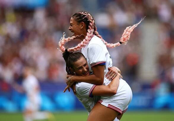 US forward Trinity Rodman, right, celebrates with teammate Emily Fox after scoring a goal against Japan on August 3. The Americans needed extra time to win 1-0 and advance to the semifinals .
