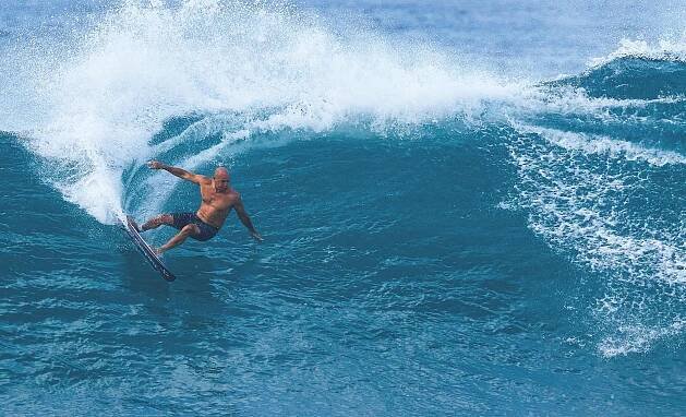 Pro surfer Kelly Slater riding a wave