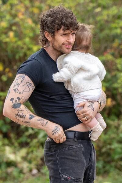 Tom Grennan holding his baby.
