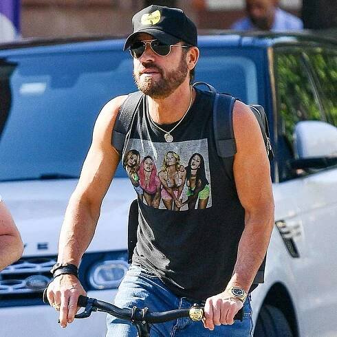 Justin Theroux and Sam Rockwell are spotted on a bike ride in New York City. Theroux wore a Wu-Tang Clan cap, sleeveless graphic shirts, jeans, and Alexander McQueen sneakers. 
