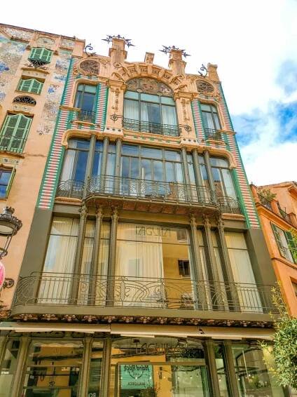 a building with green ornaments in art nouveau style in Palma de Mallorca, Spain