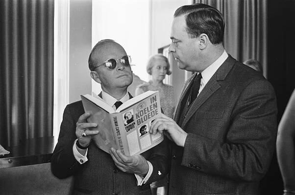 Truman Capote holding a book