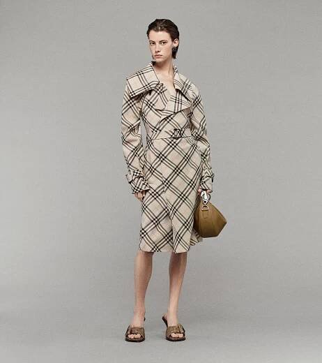 Model wearing Burberry Check Trench Dress with Coast Sandals, holding a Leather Knight Junior Bag