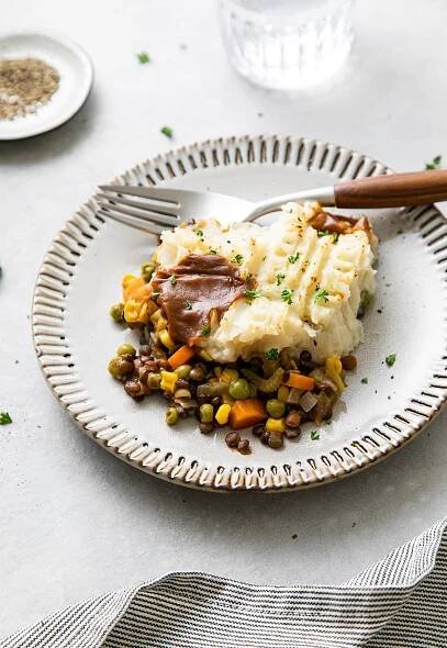 side angle view of small plate with serving of vegan shepherd's pie with fork.