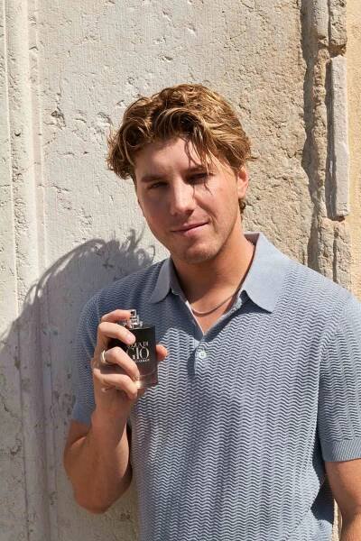 Lukas Gage holding a fragrance