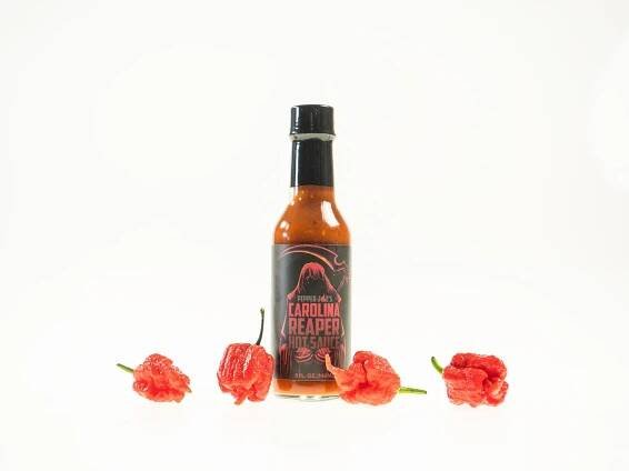 Pepper Joe's Carolina Reaper Hot Sauce Pack - Carolina Reaper hot sauce bottle with red Reapers around sauce