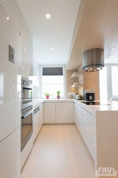 a modern kitchen with white cabinets and stainless steel appliances