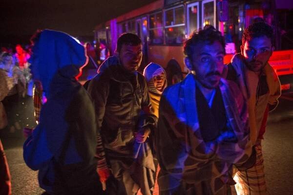  Outside Budapest, Hungary. Nervous refugees wait to board buses bound for the border between Hungary and Austria. 