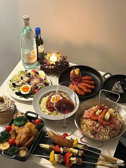 a table topped with lots of different types of food next to a bottle of wine