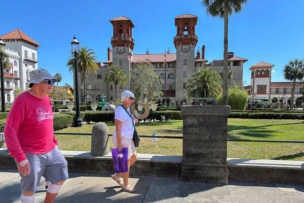 Walkers make their way through the downtown historic district in St. Augustine, Fla., which has become a top remote work hub in the U.S. during the 2020s, on Thursday, March 13, 2025.   (AP Photo/Mike Schneider.)