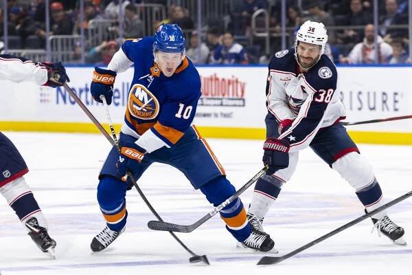 The Islanders' Simon Holmstrom moves the puck.