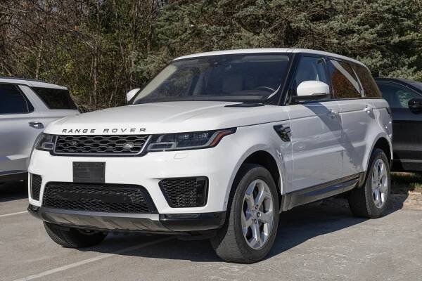 White Land Rover Range Rover Sport parked at a dealership.