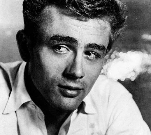 B&W photo of James Dean looking at side.
