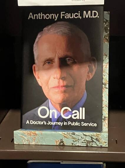 A book with a picture of Anthony Fauci on the cover, placed on the shelves in the Senate Library