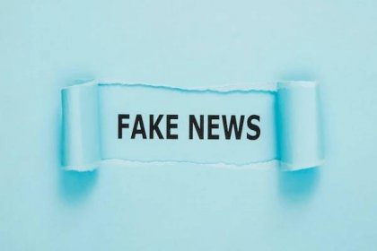 Free photo torn fake news paper on blue wall
