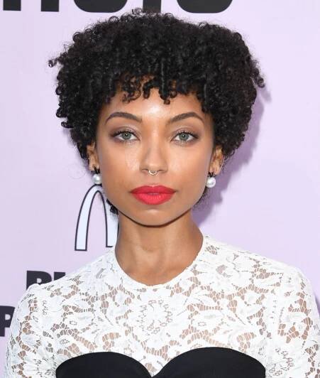 Logan Browning with a natural curly pixie cut