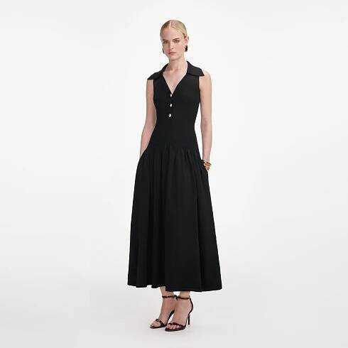 Side view of a woman wearing the Black Ribbed Knit Midi Dress