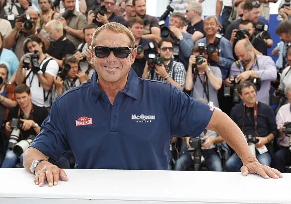 a man wearing a shirt that says mcqueen racing