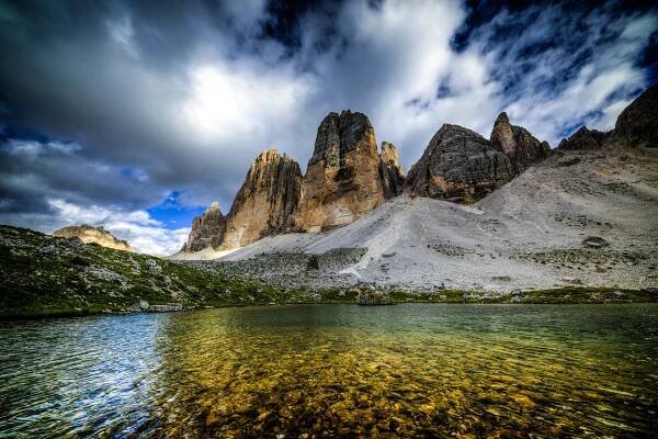 The Tre Cime di Lavaredo against a cloudy and fast moving clouds. The color of this small pond was really contrasting with the blue sky.