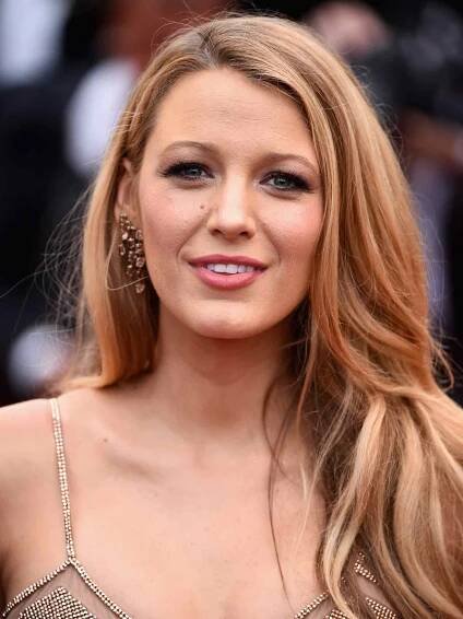 Blake Lively in a strappy rhinestone gown with dark strawberry blonde hair