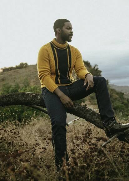 THE ELDER STATESMAN sweater, LEVI'S jeans, and DR. MARTENS shoes.