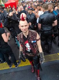 Punker leading the skinhead locked in wooden punishment stocks at Folsom Europe Street Fair, the biggest European gay fetish event, in Berlin, Germany, photo by Ivan Kralj