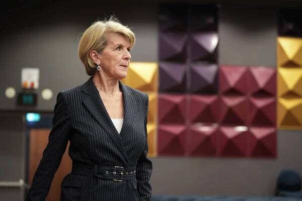 Julie Bishop walks into a press conference.