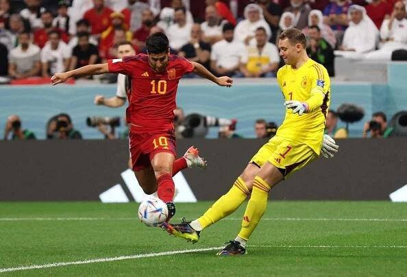 Španěl Marco Asensio (vlevo) a německý gólman Manuel Neuer.