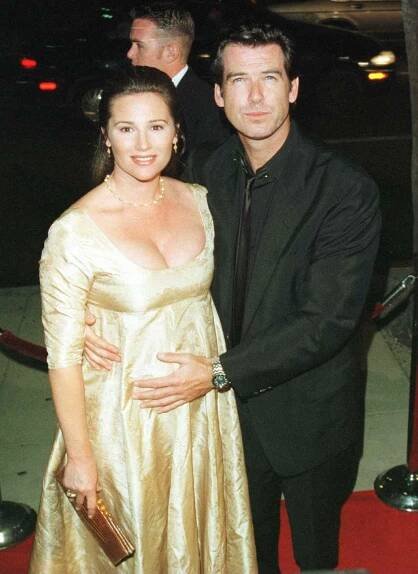 1996: Pierce Brosnan pats his pregnant girlfriend Keely Shaye Smith at the premier of Michael Collins staring Liam Neeson.