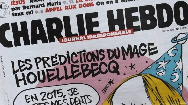 A person reads the latest issue of the French satirical newspaper Charlie Hebdo in Paris on January 7, 2015, after gunmen armed with Kalashnikovs and a rocket-launcher opened fire in the offices of the weekly in Paris, killing at least 11. AFP PHOTO / BERTRAND GUAY        (Photo credit should read BERTRAND GUAY/AFP/Getty Images)