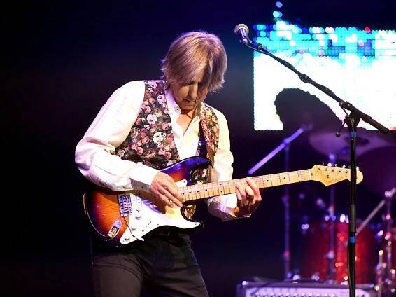 Eric Johnson on stage playing a Stratocaster
