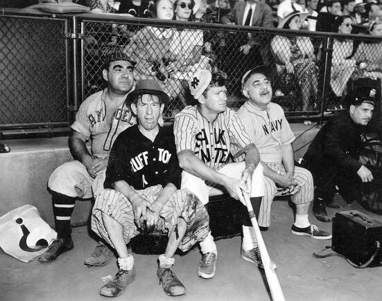Al S Hall, with Dewey Robinson, Buddy Ebsen and Henry Armetta, all film actors in Hollywood are viewed taking a break by participating in a game of baseball.