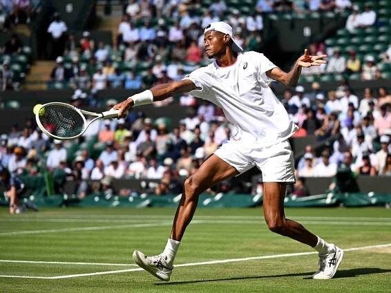 Christopher Eubanks of United States plays a backhand against Cameron Norrie of Great Britain