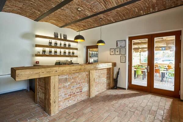 a bar in a restaurant with a brick wall at Hotel Ryzlink in Mikulov