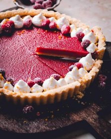 Lifting a single slice of Cranberry Curd Tart out.