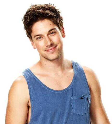 Person in a blue tank top smiling against a white background.