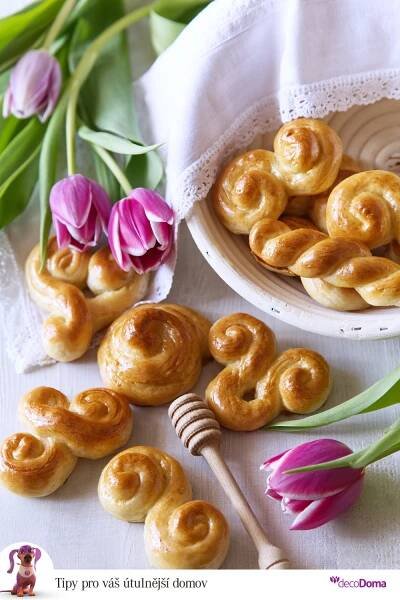 small pastries on a plate next to tulips and a honeybee stick